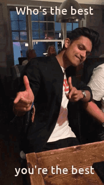 a man giving a thumbs up with the words " who 's the best you 're the best " below him