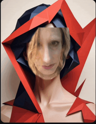 a woman 's face is partially obscured by a red and blue geometric shape