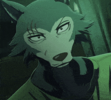 a close up of a wolf 's face with a green shirt on