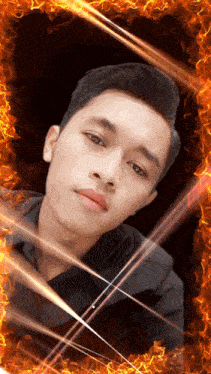 a man 's face is surrounded by flames in a photo frame