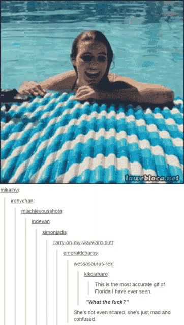 a woman is laying on a blue and white striped raft in a swimming pool