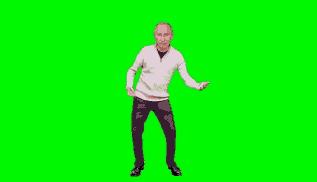 a man is dancing in front of a green screen .