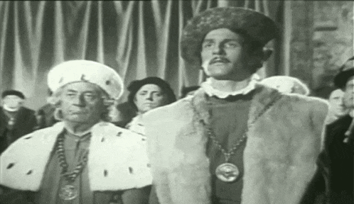 a black and white photo of a group of men in costume
