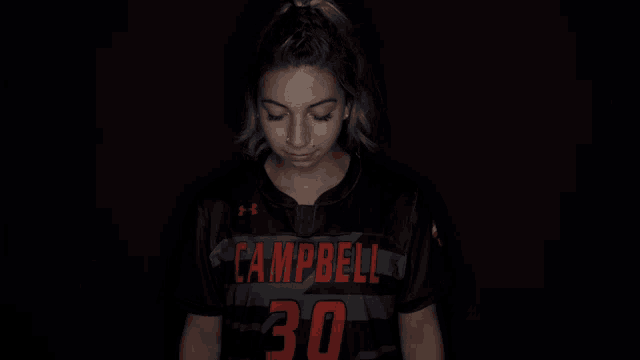 a girl wearing a black shirt with campbell on it