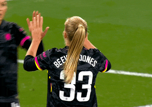 a woman wearing a jersey with the number 33 on the back