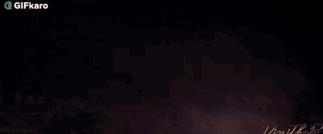 a gif of a fireworks display with the words gifkaro at the top