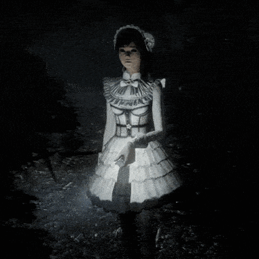 a girl in a white dress stands in the dark holding a flashlight
