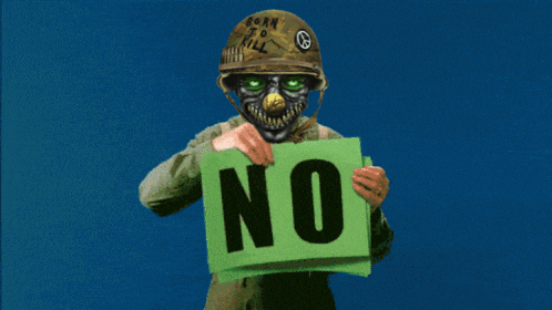 a soldier is holding a green sign that says " no "