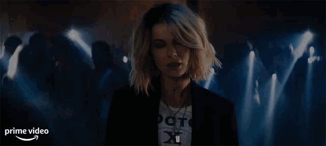 a woman is standing in front of a crowd and says " seriously "