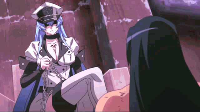 a woman in a hat with a cross on it is chained to a man