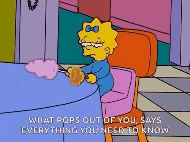 maggie simpson from the simpsons is sitting at a table with cotton candy on a stick .