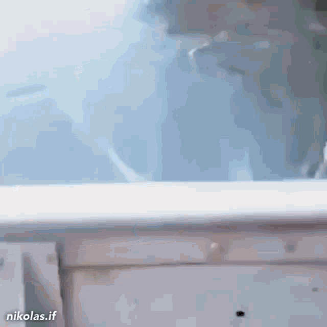 a gif of a person standing in front of a window with the url nikolas.if at the bottom