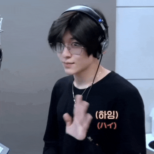 a man wearing glasses and headphones has a shirt that says " hi " on it