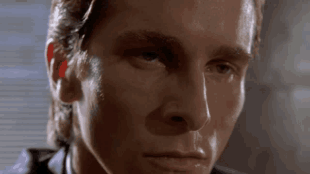 a close up of a man 's face with sweat on it