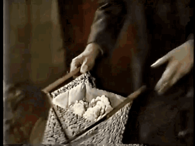a person holding a basket with a few pieces of paper in it