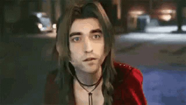 a man with long hair is wearing a choker and a red jacket .