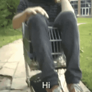 a person is sitting in a shopping cart and the word hi is visible