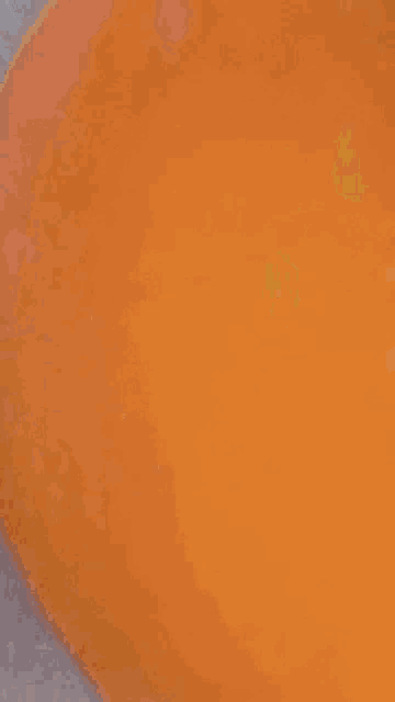 a close up of a yellow colored object with a blurred background