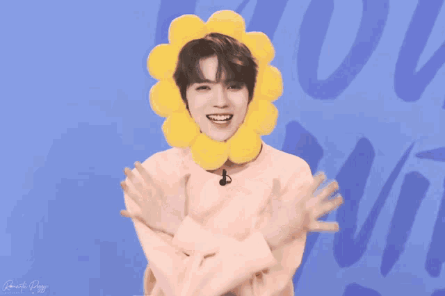 a person wearing a pink shirt with a yellow flower on it
