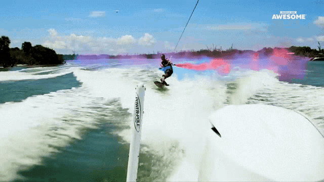 a man is riding a surfboard in the water and the words awesome are on the bottom