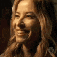 a close up of a woman 's face with a smile on her face .