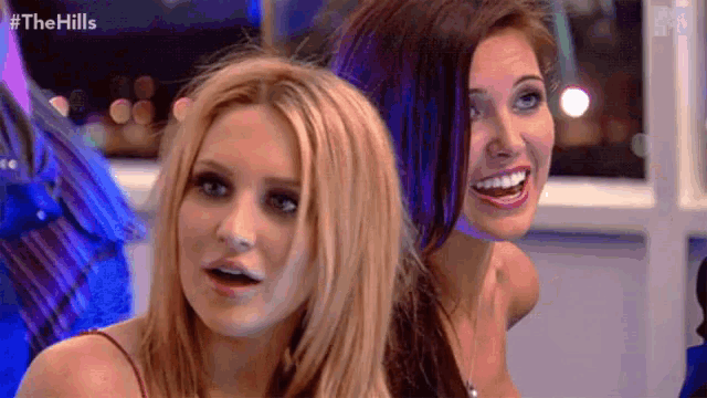 two women are standing next to each other with #thehills written on the bottom right