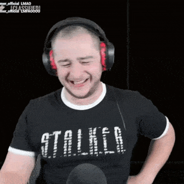 a man wearing headphones and a stalker shirt