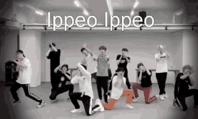 a group of young men are dancing in a room with the words ippeo ippeo written above them