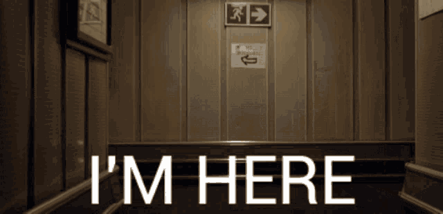 an elevator with a sign that says i 'm here on it