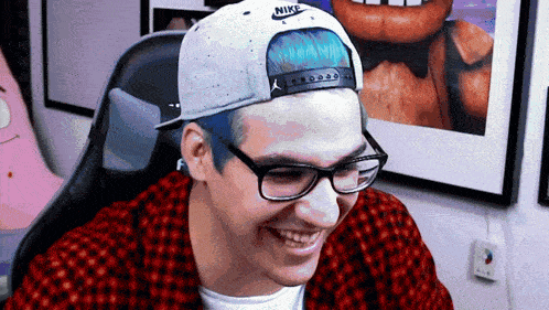 a man wearing glasses and a nike hat