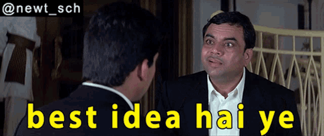 a man in a suit talks to another man with the words best idea hai ye