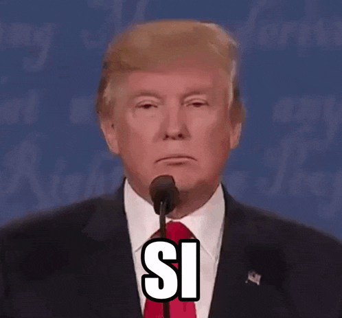 donald trump is giving a speech in front of a microphone and making a face .