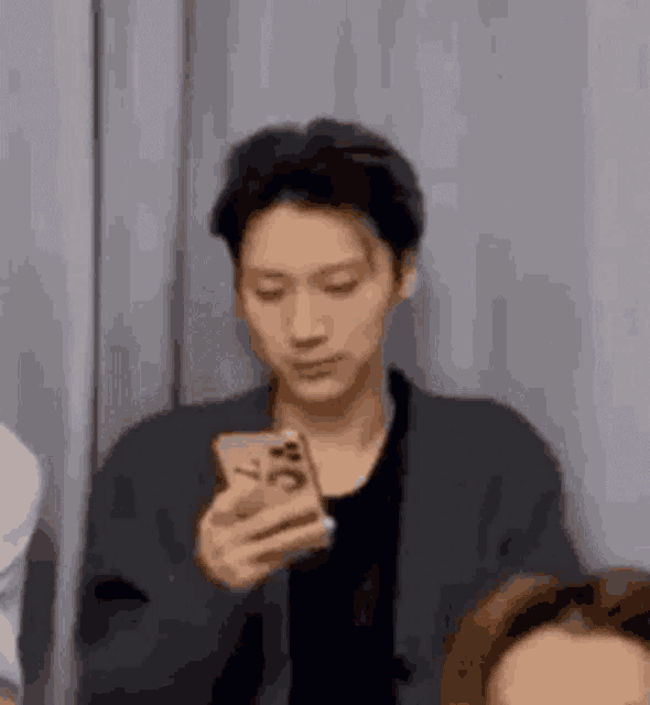 a man is holding a cell phone in his hand .