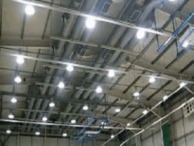 there are a lot of lights hanging from the ceiling of a building .