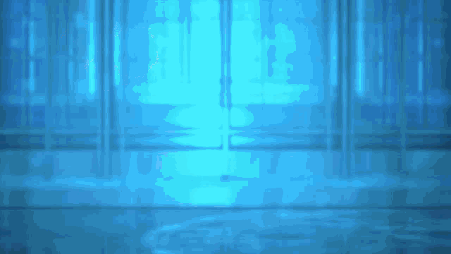 a room with a lot of windows and a blue light coming out of the window .