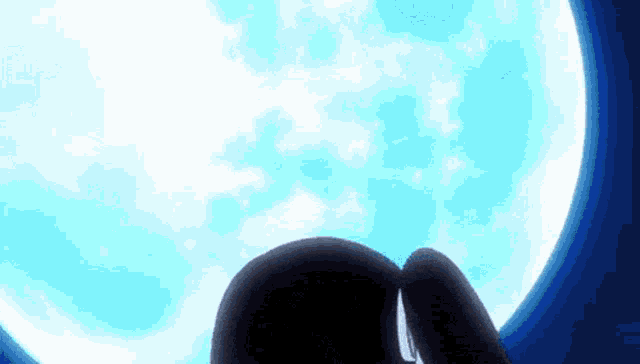 a person is looking up at a full moon in the night sky
