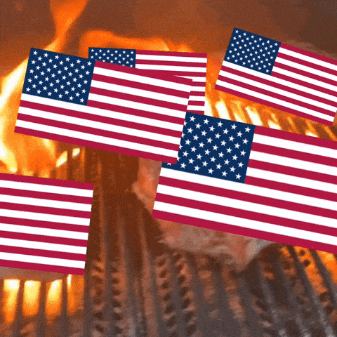 several american flags are flying over a grill with flames in the background