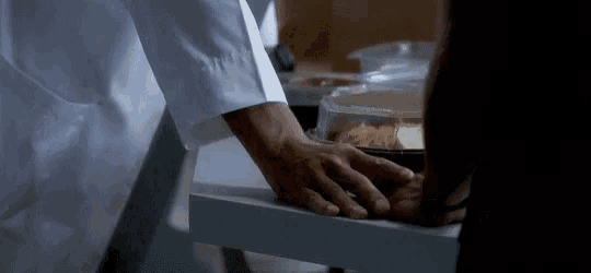 a close up of a person 's hands reaching into a drawer with food in it .