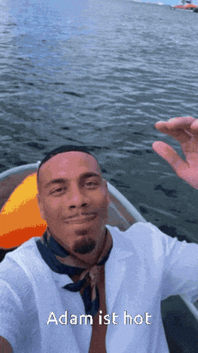 a man in a boat with the words adam ist hot on the bottom