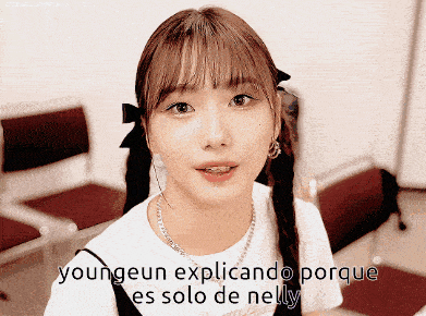 a girl with pigtails and the words youngeun explicando porque es solo de nelly on the bottom