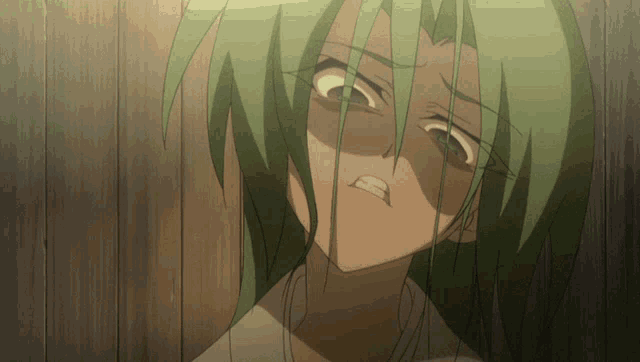a cartoon character with green hair making a face