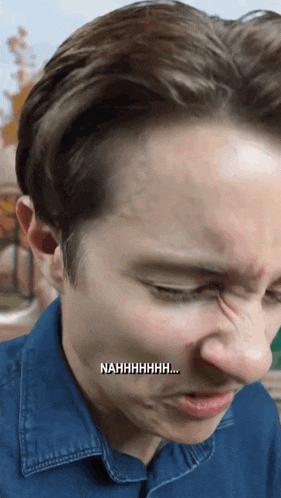 a close up of a man 's face with nahhhhhhh written on the bottom right