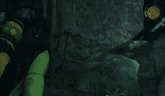 a man in a gas mask is holding a green snake in a dark room .