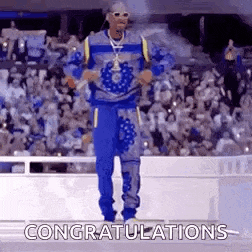 snoop dogg is standing on a stage in front of a crowd of people .