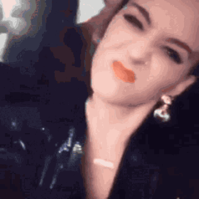 a close up of a woman 's face with a necklace and earrings