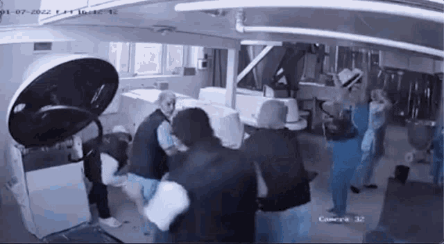 a group of people are standing around a machine that says camera on the bottom