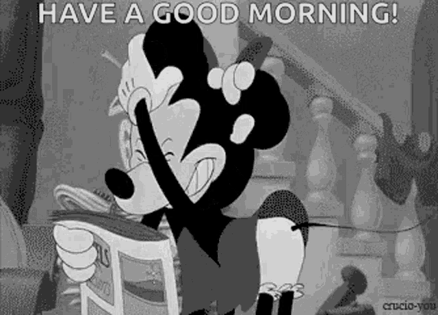 a black and white cartoon of mickey mouse reading a newspaper and talking on a cell phone .