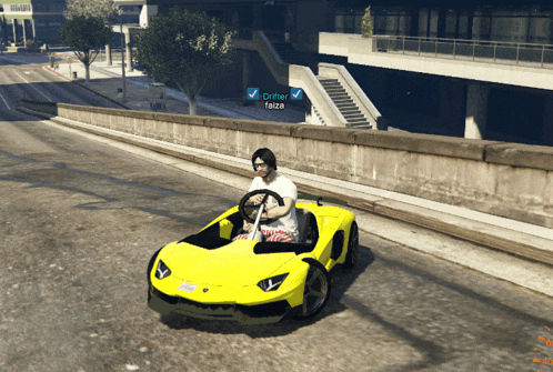 a man driving a yellow car with the name drifter on the side
