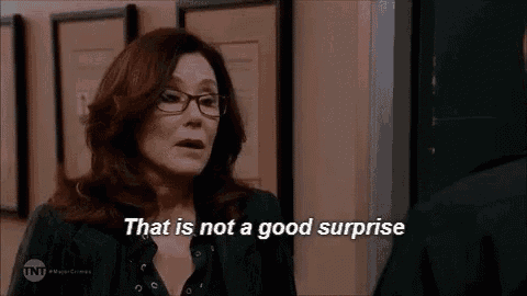 a woman wearing glasses is talking to a man in a room and saying `` that is not a good surprise '' .