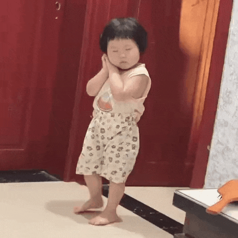 a little girl is standing on a tiled floor in a hallway .
